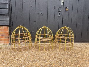 three herbaceous domed plant supports woven from willow