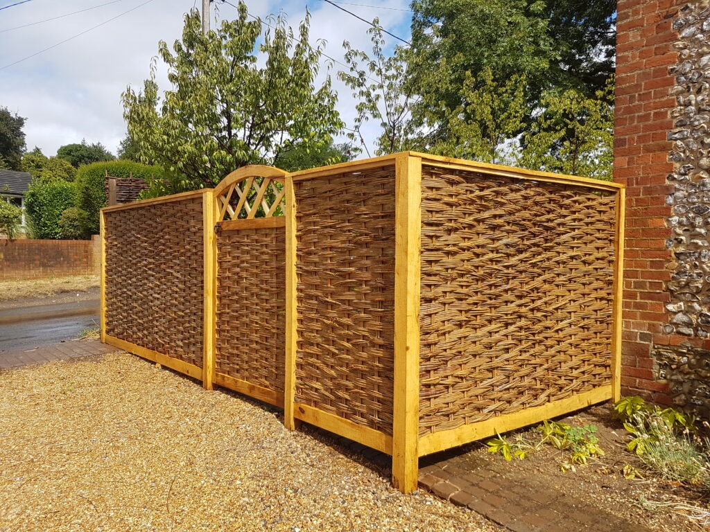 Woven garden wheelie bin screen. Framed hurdle panels with matching gate