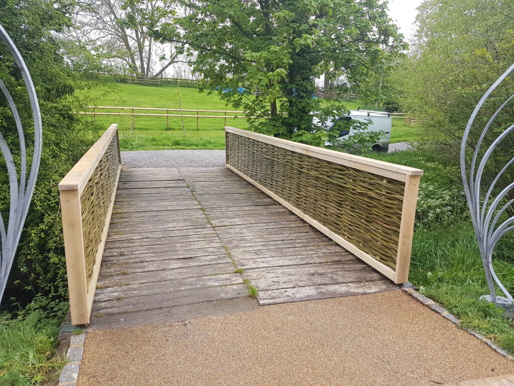 Natural woven bridge railings in a sculptural garden