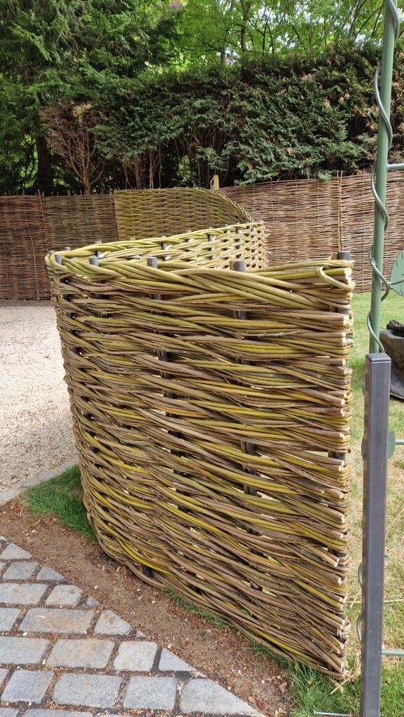 close up of the weave in a curving woven willow fence