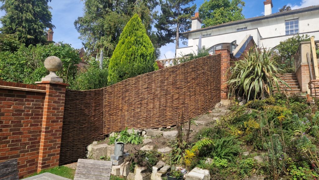 continuous woven willow fence on a slope