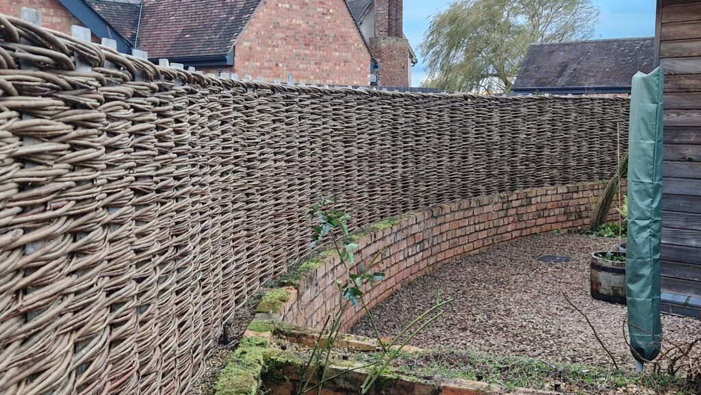 curved willow hurdle on a wall